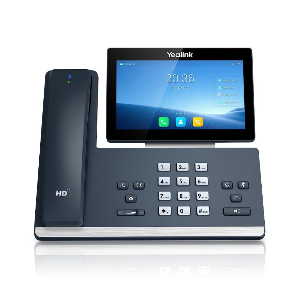 A black T58W Pro IP Phone displayed from a frontal view on a white background. The phone features a 7 inch (1024 x 600) capacitive adjustable touch screen. The silver number buttons on the dashboard and other functionality buttons are clearly visible.