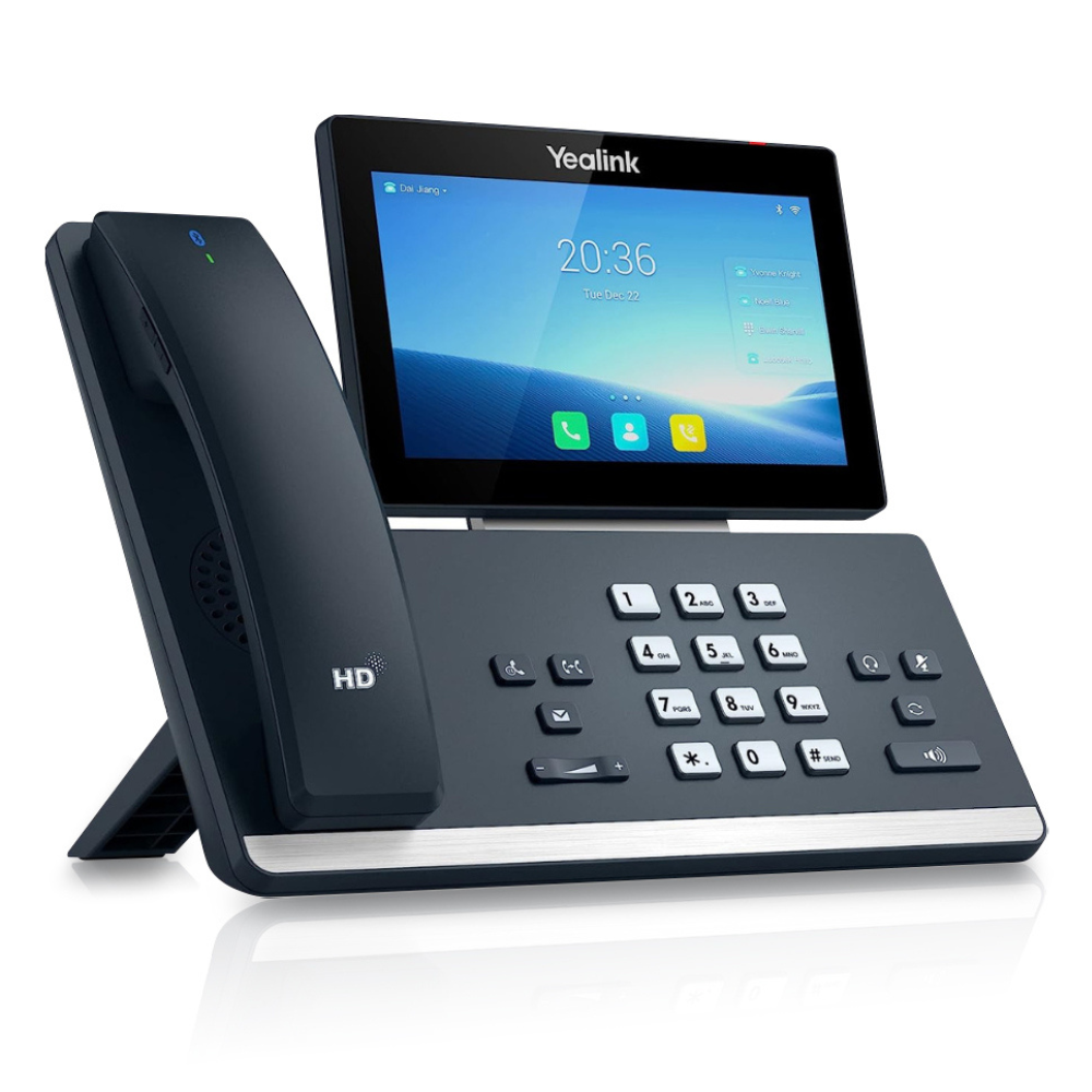 A left-angled view of a black T58W Pro IP Phone displayed on a white background. The phone features a 7 inch (1024 x 600) capacitive adjustable touch screen. The silver number buttons on the side panel and other functionality buttons are clearly visible.
